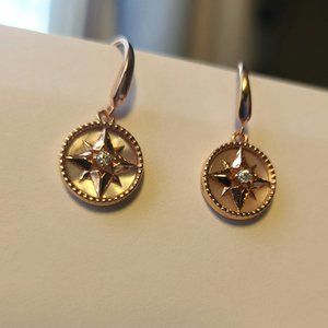 Rose gold, starburst drop earrings with black stretch band pearl bracelet.